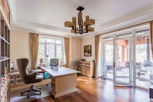 Interior design of a home office with desk, shelves, etc., in a house